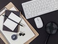 Office desk table of Business workplace and business objects of keyboard,mouse,white paper,notebook,pencil,compass on black table Royalty Free Stock Photo