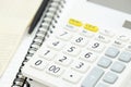 Office desk table calculator with notepad book, bank account and black pen.