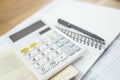 Office desk table calculator with notepad book and black pen. Royalty Free Stock Photo