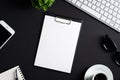 Office desk table with clipboard, computer keyboard, coffee cup, smartphone, notepad and pen. Top view with copy space, flat lay. Royalty Free Stock Photo