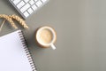 Office desk table with coffee cup, computer keyboard, paper notebook, wheat on green background. Flat lay, top view with copy Royalty Free Stock Photo