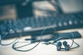 Office desk table with computer, smartphone and headphones. Essential items black color on light desk. Workplace concept Royalty Free Stock Photo