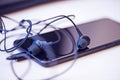 Office desk table with computer, smartphone and headphones. Essential items black color on light desk. Workplace concept Royalty Free Stock Photo