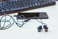 Office desk table with computer, smartphone and headphones. Essential items black color on light desk. Workplace concept Royalty Free Stock Photo