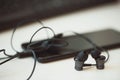 Office desk table with computer, smartphone and headphones. Essential items black color on light desk. Workplace concept Royalty Free Stock Photo