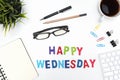 Office desk table with happy wednesday word