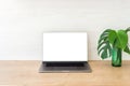 Office desk table with laptop computer with blank screen mockup and monstera plant on wooden surface. Minimal style workplace Royalty Free Stock Photo