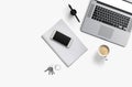 Office desk table with laptop computer, smartphone with black screen over a notebook and cup of coffee. Top view. Royalty Free Stock Photo