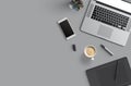 Office desk table with laptop computer, smartphone with black screen over a notebook and cup of coffee. Top view. Royalty Free Stock Photo