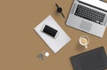 Office desk table with laptop computer, smartphone with black screen over a notebook and cup of coffee. Top view. Royalty Free Stock Photo