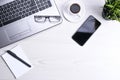 Office desk table with laptop, smart phone, cup of coffee and supplies, on wooden background. Top view with copy space, flat lay Royalty Free Stock Photo