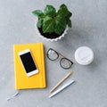 Office desk table with notebook planner, smart phone, glasses and coffee cup. Royalty Free Stock Photo