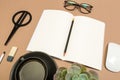 Office desk table with  notebook scissors glasses coffee cup succulent and pencil. Mock up template . Top view Royalty Free Stock Photo