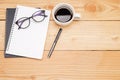 Office desk table with smartphone, pen on notebook, cup of coffee and flower. Top view with copy space (selective focus).. Royalty Free Stock Photo