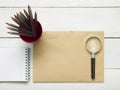 Office desk table with supplies. Magnifying glass, pencil and empty blank sheet of paper. Top view. Copy space for text Royalty Free Stock Photo