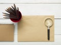 Office desk table with supplies. Magnifying glass, pencil and empty blank sheet of paper. Top view. Copy space for text Royalty Free Stock Photo