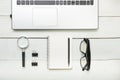 Office desk table with supplies. Top view. Copy space for text. Laptop, blank notepad, and magnifying glass Royalty Free Stock Photo
