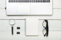 Office desk table with supplies. Top view. Copy space for text. Laptop, blank notepad, and magnifying glass Royalty Free Stock Photo