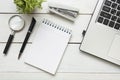 Office desk table with supplies. Top view. Copy space for text. Laptop, blank notepad, pen, magnifying glass, calculator Royalty Free Stock Photo