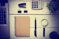 Office desk table with supplies. Top view. Copy space for text. Laptop, blank notepad, pen, magnifying glass, calculator Royalty Free Stock Photo