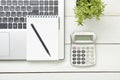 Office desk table with supplies. Top view. Copy space for text. Laptop, notepad, pen, calculator and flower. Royalty Free Stock Photo