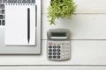 Office desk table with supplies. Top view. Copy space for text. Laptop, notepad, pen, calculator and flower. Royalty Free Stock Photo