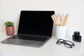 Office desk table with supplies. Top view. Copy space for text. Laptop,  pensils, glass,  flower. Royalty Free Stock Photo