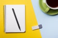 Office desk table with supplies top view. Notepad, pen and colorful paper. Copy space for text