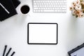 Office desk table with tablet,coffee cup ,pencil ,flower on white desk. Top view with copy space Royalty Free Stock Photo