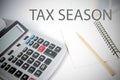 Office desk table with TAX SEASON word on calculator Royalty Free Stock Photo