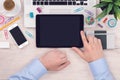 Office desk table workplace with ipad digital tablet pc and mans hands on it top view flat lay Royalty Free Stock Photo