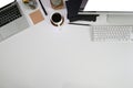 Office desk with top view, Laptop and PC empty screen with coffee and cactus on white table Royalty Free Stock Photo