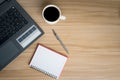 Office Desk Top view Workplace With Wooden Desk, Laptop, Notepad, Pen and Dark Hot Coffee Royalty Free Stock Photo