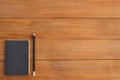 Office desk wooden table background with mock up notebooks and pencil and plant. Royalty Free Stock Photo