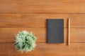 Office desk wooden table background with mock up notebooks and pencil and plant. Top view with copy space, flat lay photography. Royalty Free Stock Photo