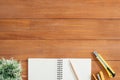 Office desk wooden table background with open mock up notebooks and pens and plant. Royalty Free Stock Photo