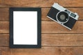 Office desk wooden table with old camera and poster mockup template. Top view with copy space. Royalty Free Stock Photo