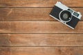 Office desk wooden table with old camera. Top view with copy space. Top view of old camera over wooden table. Retro vintage filter Royalty Free Stock Photo