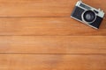 Office desk wooden table with old camera. Top view with copy space. Top view of old camera over wooden table. Retro vintage filter Royalty Free Stock Photo