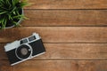 Office desk wooden table with old camera and tree. Top view with copy space. Top view of old camera over wooden table. Royalty Free Stock Photo