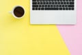 Flat lay top view copy space of a working space with laptop, a coffee cup and little grass placing on pastel background. Royalty Free Stock Photo