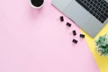 Flat lay top view copy space of a working space with laptop, a coffee cup and little grass placing on pastel background. Royalty Free Stock Photo