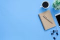 Flat lay top view mockup photo of working space with tablet, phone, coffee cup and notebook on blue pastel background. Royalty Free Stock Photo