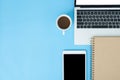 Flat lay top view mockup photo of working space with laptop, smartphone, coffee and stationary on blue pastel background. Royalty Free Stock Photo