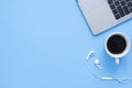 Flat lay top view mockup photo of a working space with laptop, coffee cup and smartphone on blue pastel background. Royalty Free Stock Photo