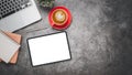 Office desk workplace with blank screen digital tablet for product display, laptop, notebook, pen and cup of coffee, Top view flat Royalty Free Stock Photo