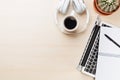 Office desk workplace with laptop, coffee and headphones Royalty Free Stock Photo