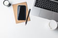 Office desk. Workplace with a modern laptop, candle, paper cup of coffee, notebook, pencil, smartphone. Concept freelancer`s work Royalty Free Stock Photo