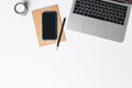 Office desk. Workplace with a modern laptop, candle, paper cup of coffee, notebook, pencil, smartphone Royalty Free Stock Photo