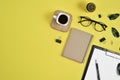 Office desk workspace with blank clip board, office supplies, pen, cactus, green leaf, coffee cup on a wooden stand and eye Royalty Free Stock Photo